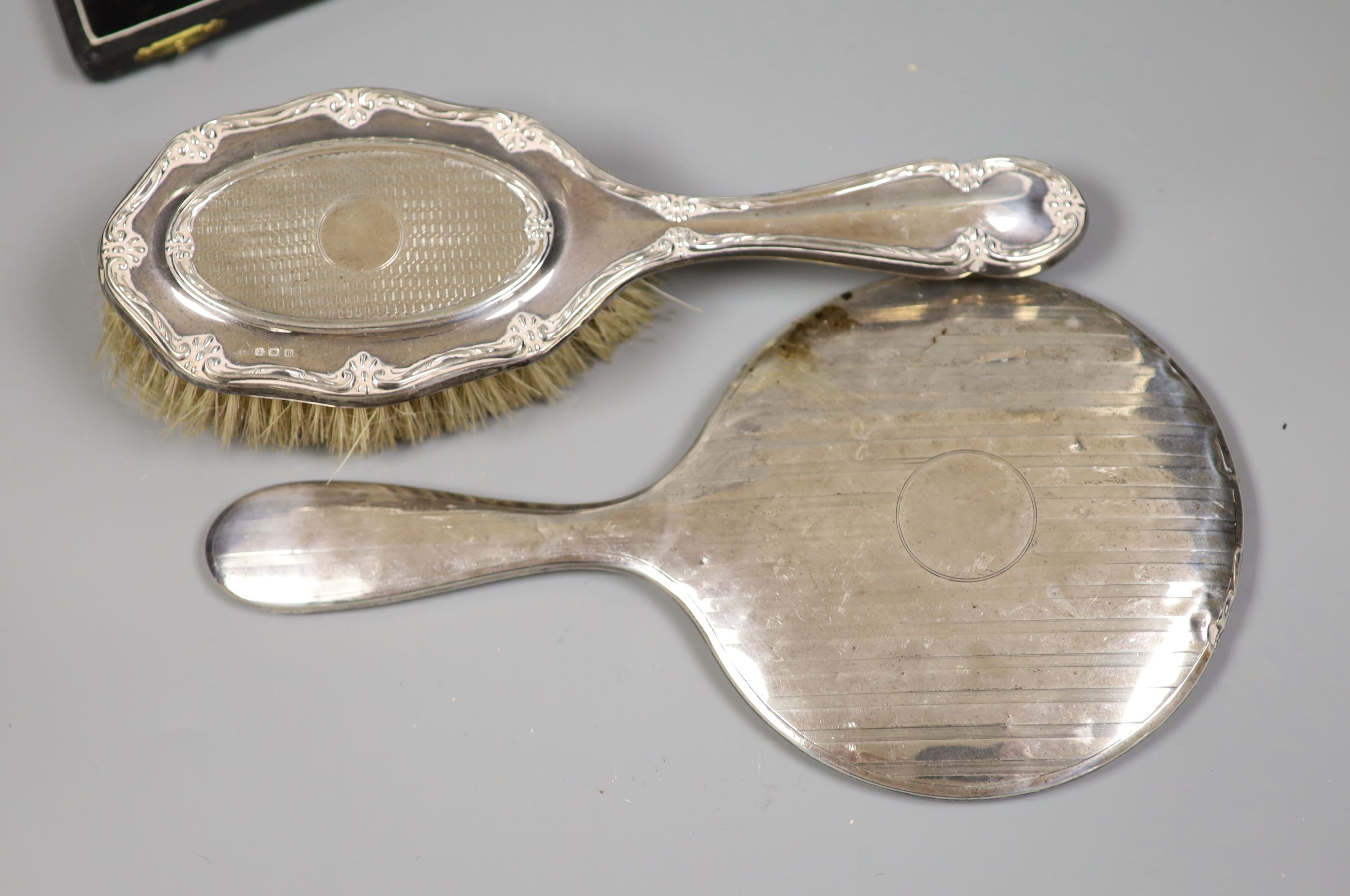 A collection of small silver including condiments, mirror and brushes, astray, cased items and a pair of sterling servers.